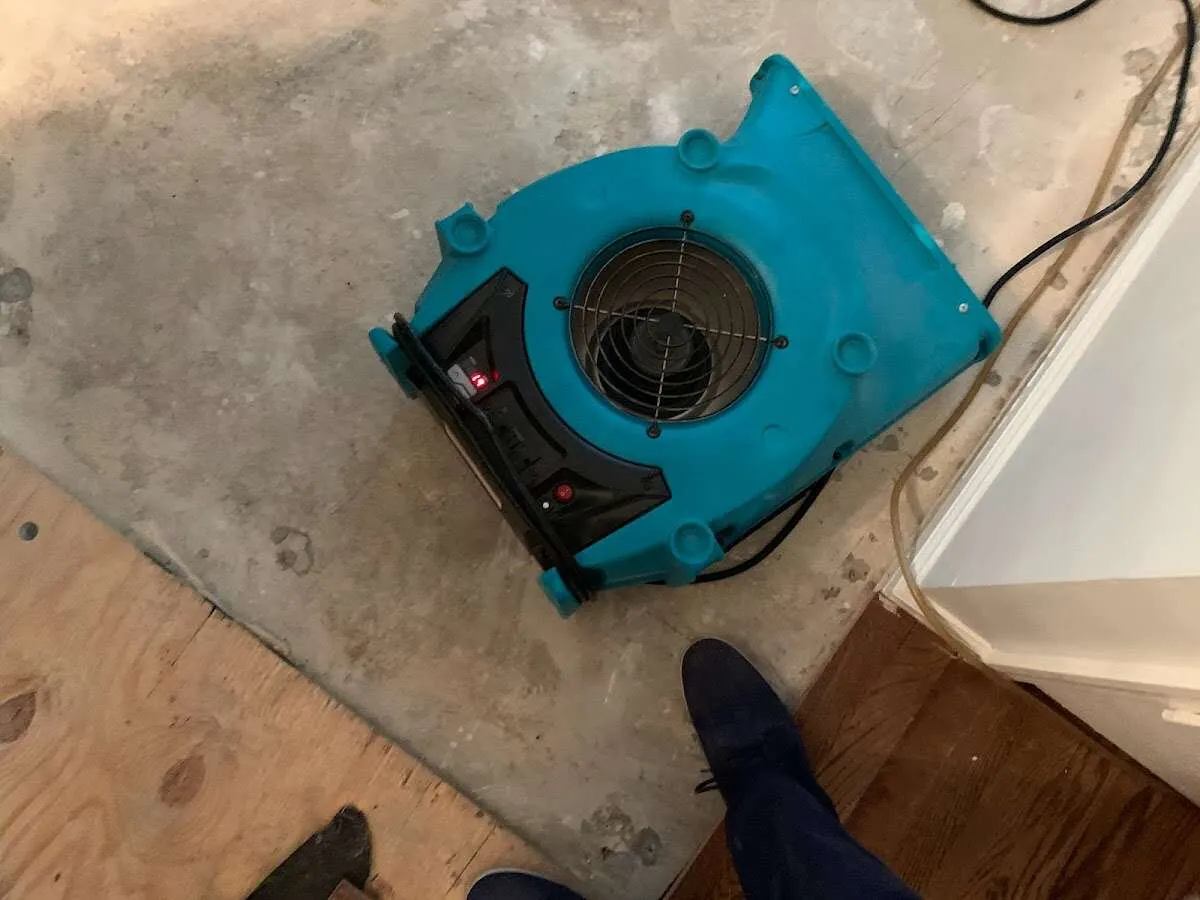 Air mover drying subfloor during Commercial Water Damage Restoration in South Portland